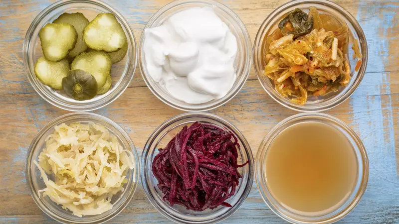a set of fermented food great for gut health - top view of glass bowls against grunge wood: cucumber pickles, coconut milk yogurt, kimchi, sauerkraut, red beets, apple cider vinegar a set of fermented food great for gut health - top view of glass bowls against grunge wood: cucumber pickles, coconut milk yogurt, kimchi, sauerkraut, red beets, apple cider vinegar