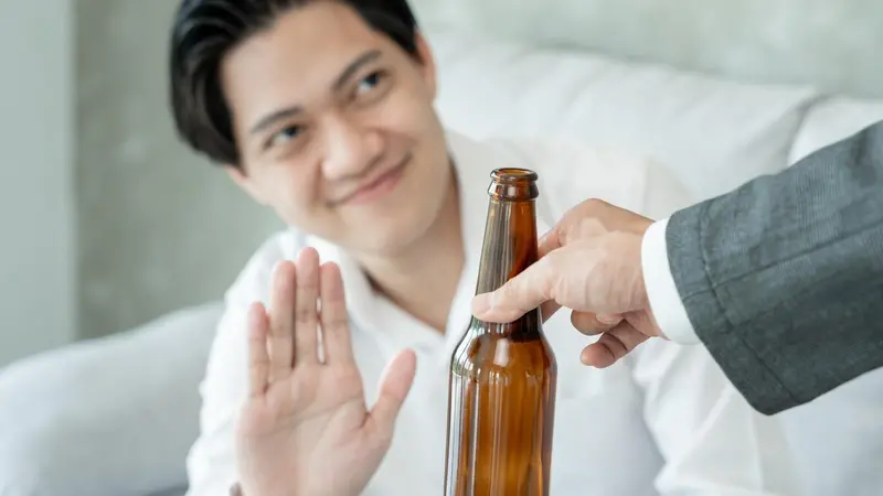 Young man saying no to a beer Young man saying no to a beer