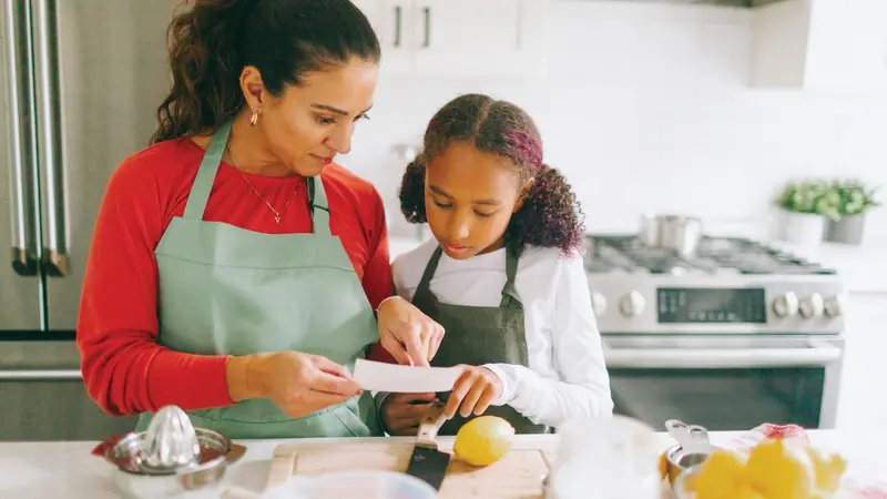 Mother and daughter cooking together Mother and daughter cooking together