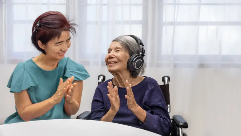 Music therapy in dementia treatment on elderly woman Music therapy in dementia treatment on elderly woman