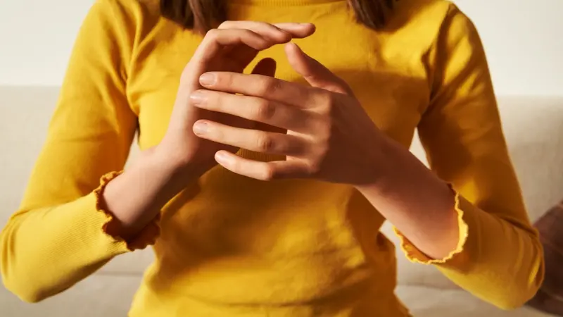 Woman practicing EFT tapping technique using her hands Woman practicing EFT tapping technique using her hands