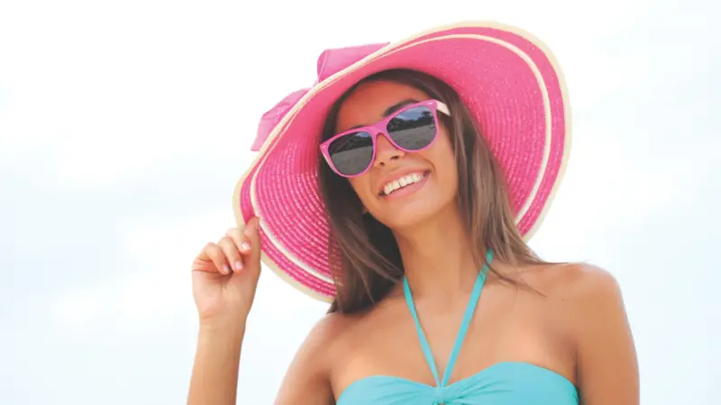 Woman in sunglasses and pink sun hat Woman in sunglasses and pink sun hat
