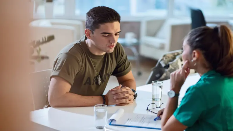 Young military solider having an appointment with doctor