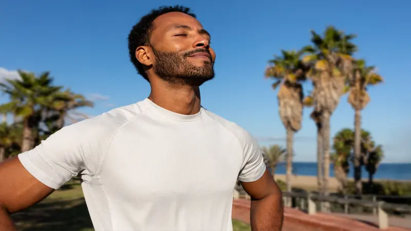 African American man breathing deeply in nature, relaxation and calm African American man breathing deeply in nature, relaxation and calm