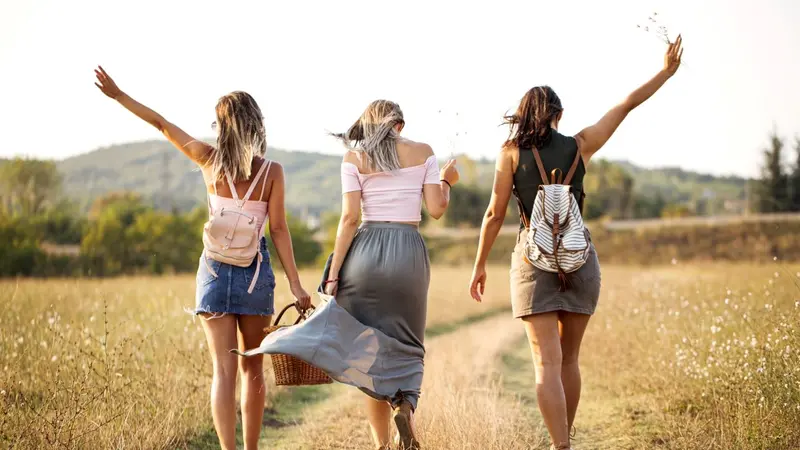 Three women walking without a care Three women walking without a care
