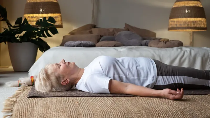Senior caucasian woman practicing nidra yoga Senior caucasian woman practicing nidra yoga