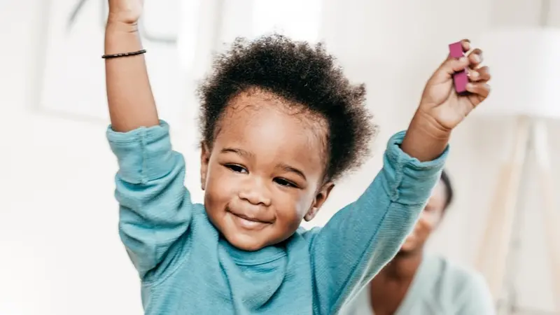 Toddler with his hands in the air Toddler with his hands in the air