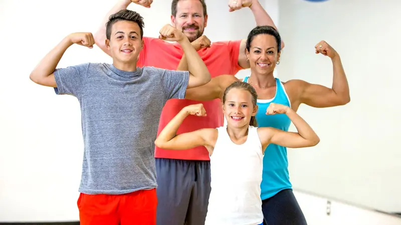 A family flexing their muscles