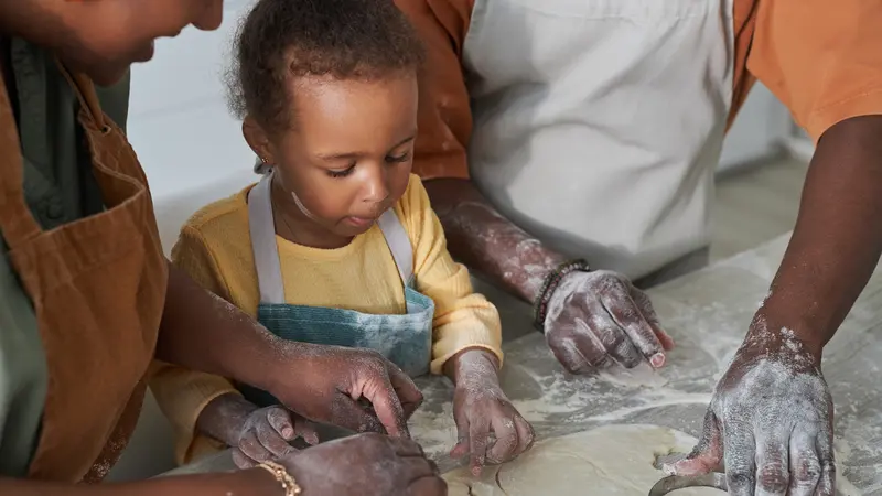 Small child learns how to bake in a teaching kitchen