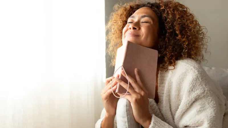 Woman manifesting in her journal