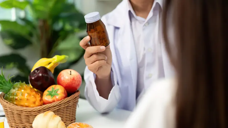 Fruit-based supplement bottle being shown to patient