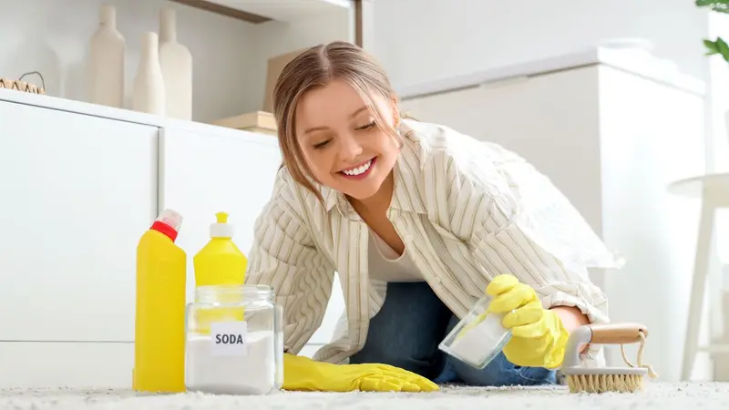 Young woman cleaning with baking soda