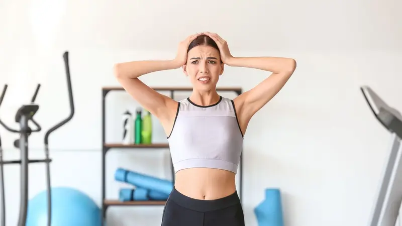 Stressed woman in work-out clothes