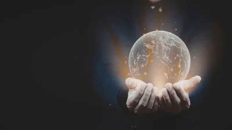 Image of hands on a black background holding a futuristic globe of interconnected nodes, signaling the future of medical research