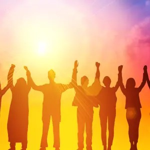 People standing together raising hands in the air