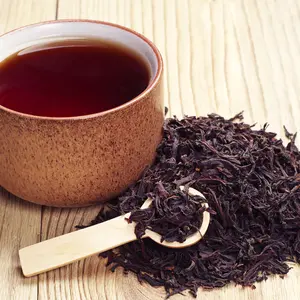 Black Tea in a cup and dried leaves