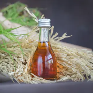 Rice bran oil in bottle glass and unmilled rice
