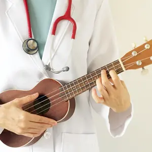 Doctor playing ukulele for Music therapy