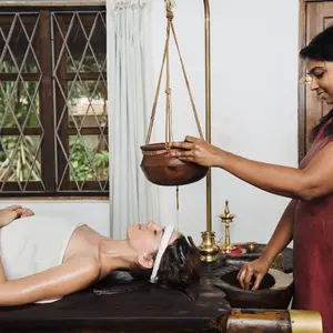 woman receiving Shirodhara technique