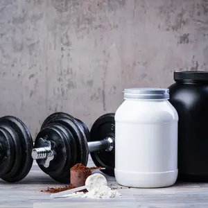 black dumbbells with two protein jars