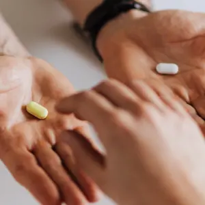 hands with vitamins and medicine