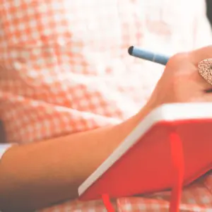 woman writes in notebook