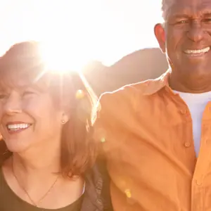 Portrait Of Smiling Senior Friends Walking In Countryside Together