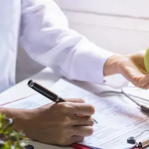 Nutritionist giving consultation to patient with healthy fruit and vegetable