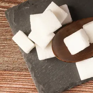 Sugar cubes with wooden spoon