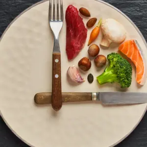 20:4 fasting diet concept. One third plate with healthy food and two third plate is empty.