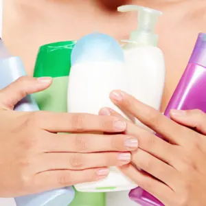 Woman with bottles of different hygiene products