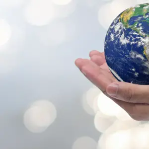 man hand gesture palm up holding world on blurred peaceful water surface background