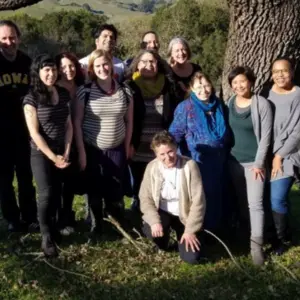 IM4US Team of People Standing Under A Large Tree