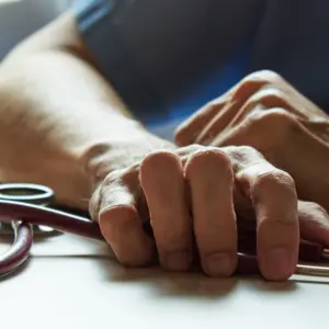 burnout surgeon feeling tired in medical office with a stethoscope on the table