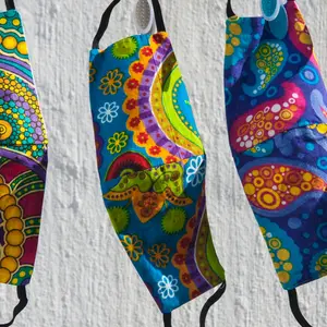 Colorful South African fabric face masks for Covid-19 protection hanging out to dry on a clothesline