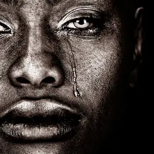 Black woman crying isolated on Black