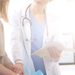 Doctor and patient discussing something while sitting at the table 