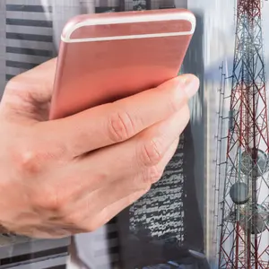 Double exposure of businessman use smartphone, communication tower or 4G 5G network