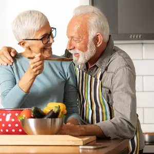 senior couple cooking a meal together at home