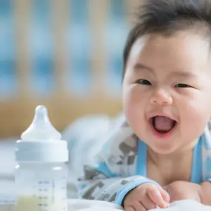 baby smile with milk bottle