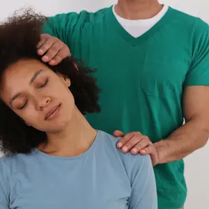 Woman having chiropractic back adjustment in rehabilitation clinic