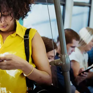 Young woman using a smartphone in a subway