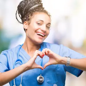 nurse showing heart symbol and shape with hands