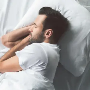 young man sleeping on bed