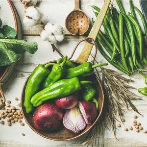 Flat-lay of vegetables, fruit, beans, cereals, kitchen utensil, dried flowers, olive oil over white wooden background, top view. 