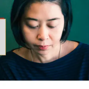 Portrait of unhappy Asian woman. Green wall background.