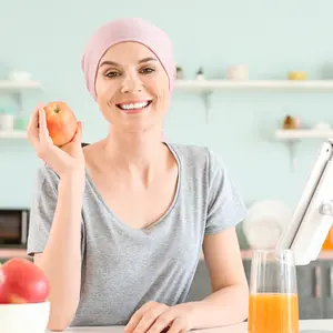 Woman after chemotherapy in kitchen at home