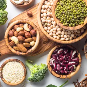 Vegan protein source. Beans, lentils, nuts, broccoli spinach and seeds. Top view on white table. Healthy vegetarian food.