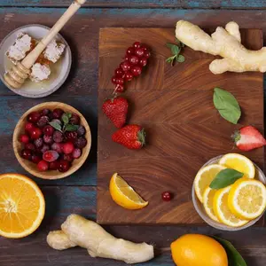 collection of foods, fruit, berries, ginger and honey on a cutting board
