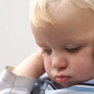 Young boy covering ears